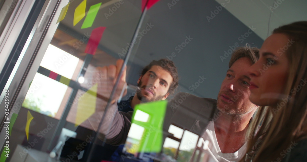 Young team listening attentively to business leader's brainstorming concept