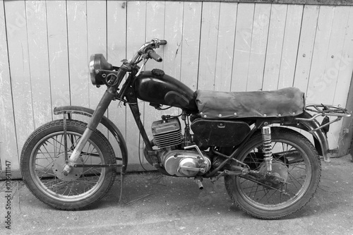 Retro motorcycle. Black and white photo. Old vintage card.