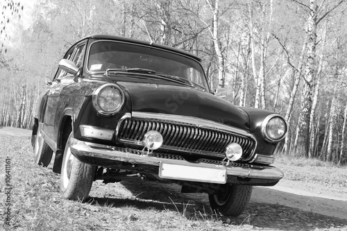 Retro car. Black and white photo. Old vintage card.