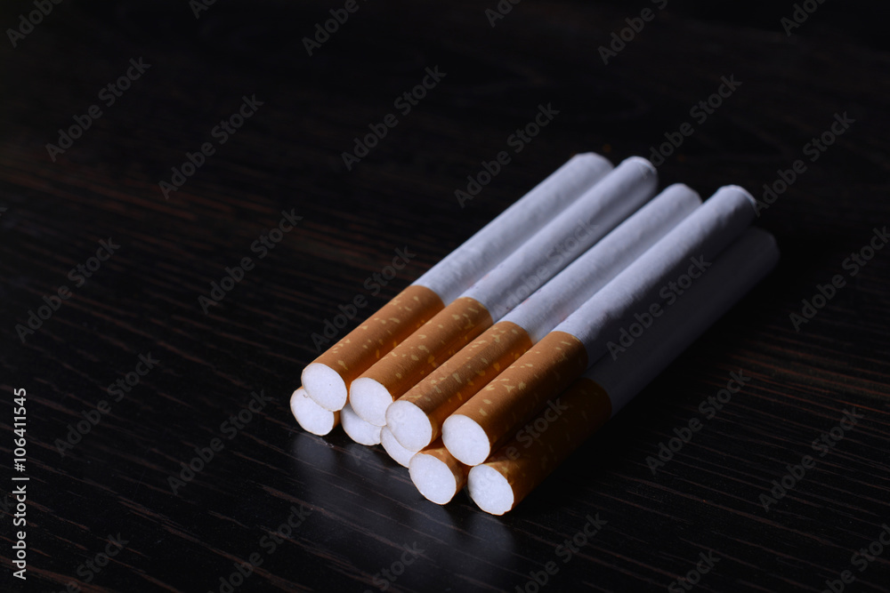 Stack of Cigarettes on black background Stack of Cigarettes on black background