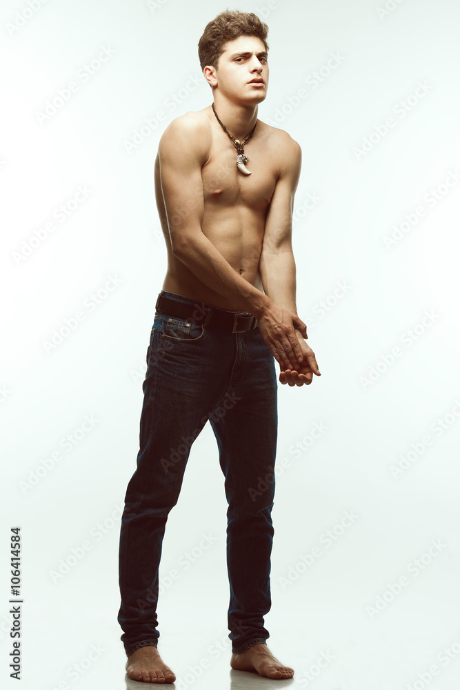 Male beauty & Blue jeans concept. Handsome male model in jeans Male beauty & Blue jeans concept. Handsome male model in jeans
