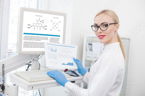 Skillful female researcher working with modern technology