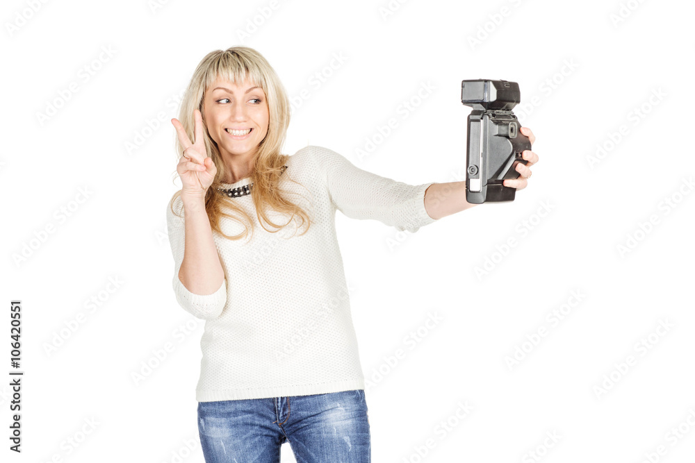 portrait of young woman taking selfie on retro camera. isolated on white background. vintage and lifestyle concept portrait of young woman taking selfie on retro camera. isolated on white background. vintage and lifestyle concept