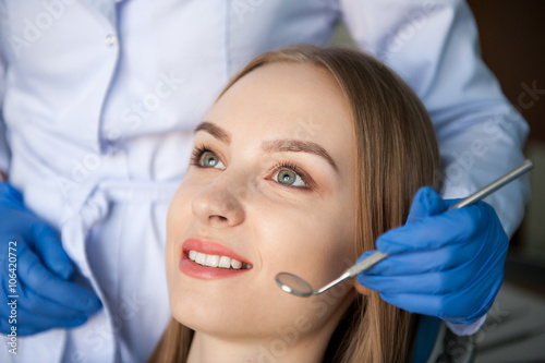 Dentist examining a patient s teeth