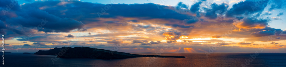 Sunset in sea and island on horizon