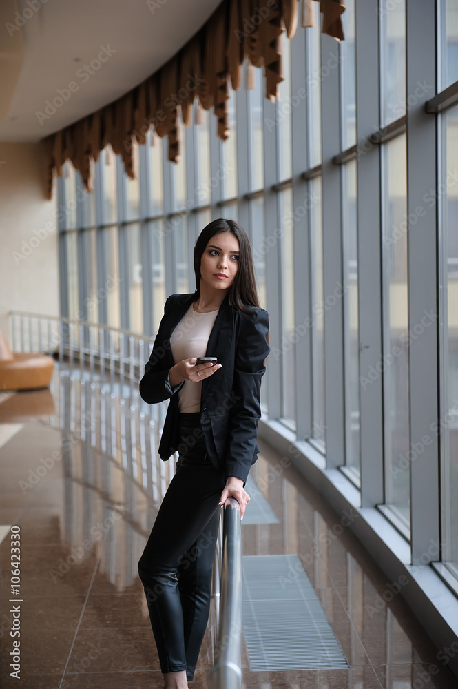 Young brunette woman is looking through the window on the planes