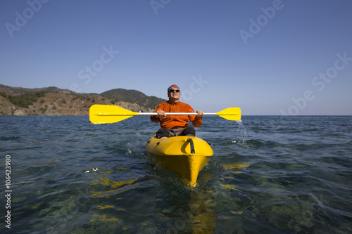 A man traveling by sea kayak. © vetal1983