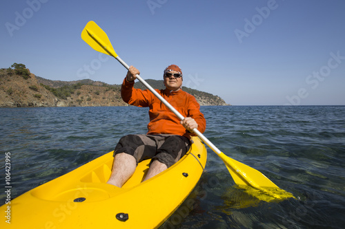 A man traveling by sea kayak.