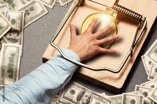 Male hand picking a gold coin photo