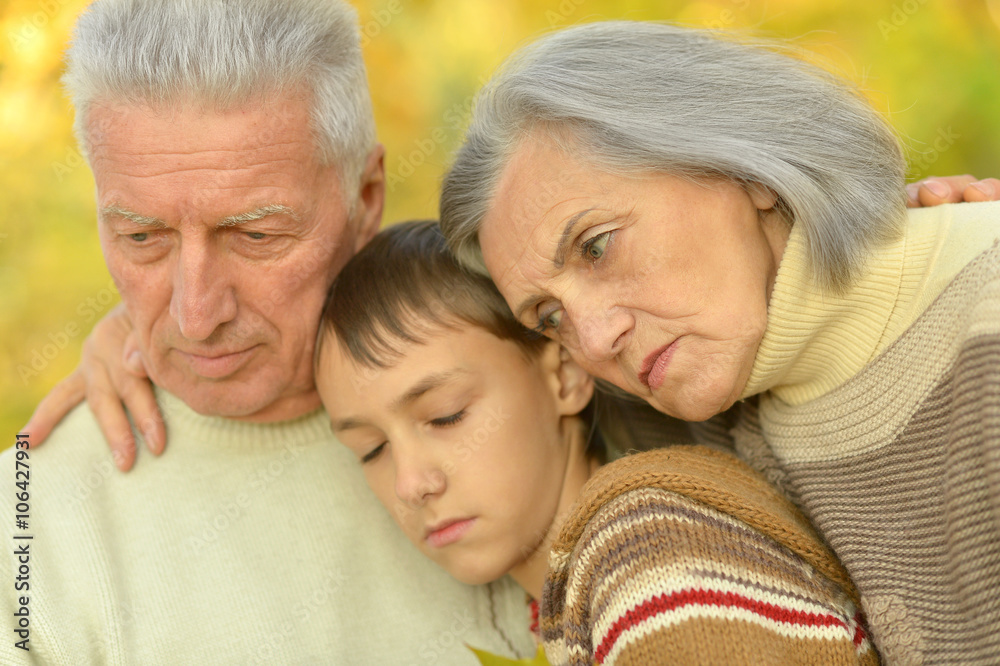 Sad grandparents with boy in park Sad grandparents with boy in park
