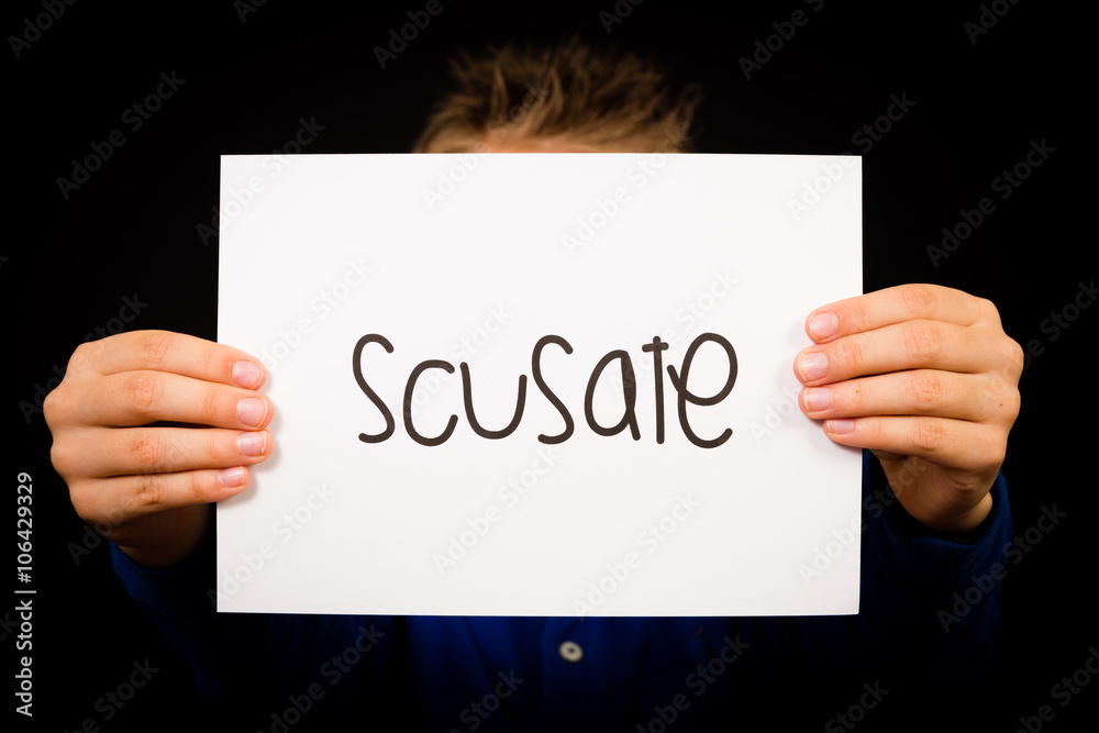 Child holding sign with Italian word Scusate - Sorry Child holding sign with Italian word Scusate - Sorry