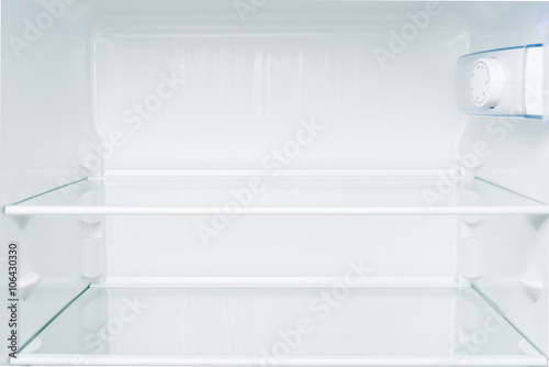 Empty shelves in refrigerator. Diet and hunger concept
