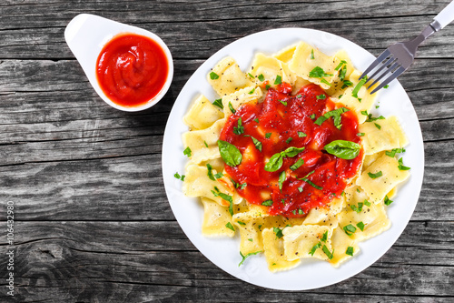 Italian ravioli with tomato sauce, top view