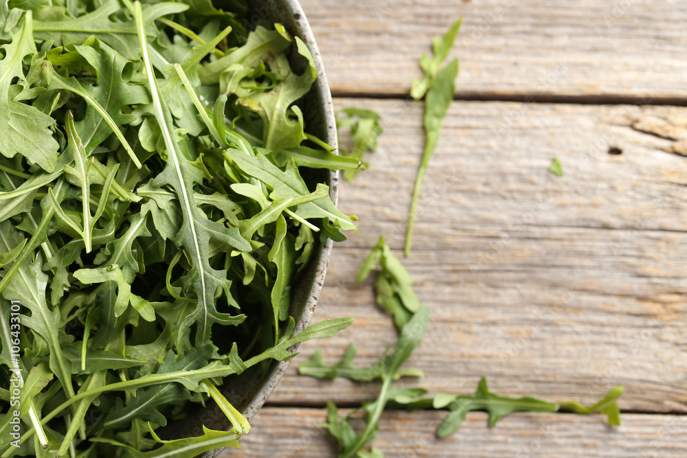 Fresh arugula leafs on a grey wooden table Fresh arugula leafs on a grey wooden table