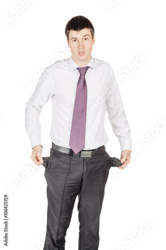 portrait of young  business man showing his empty pocket, turnin photo