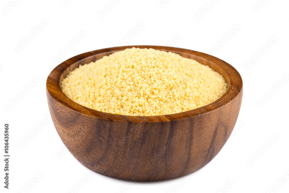 Raw couscous in a wooden bowl Raw couscous in a wooden bowl