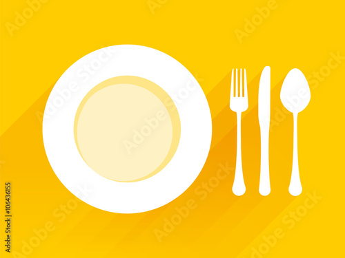 Plate with spoon knife fork on a yellow background