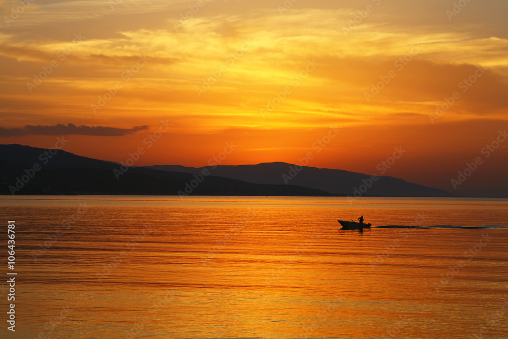 a fisherman at sunset a fisherman at sunset