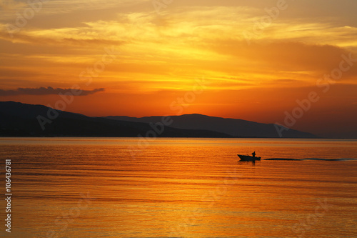 a fisherman at sunset