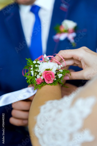 Boutonniere on a hand of the bride