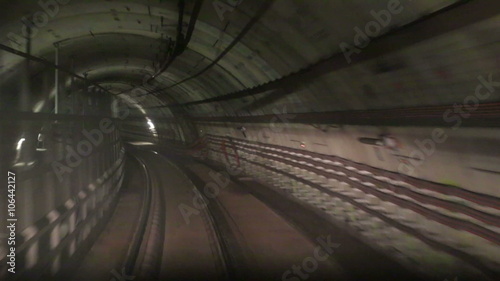 Movement along the rails in  subway tunnel photo