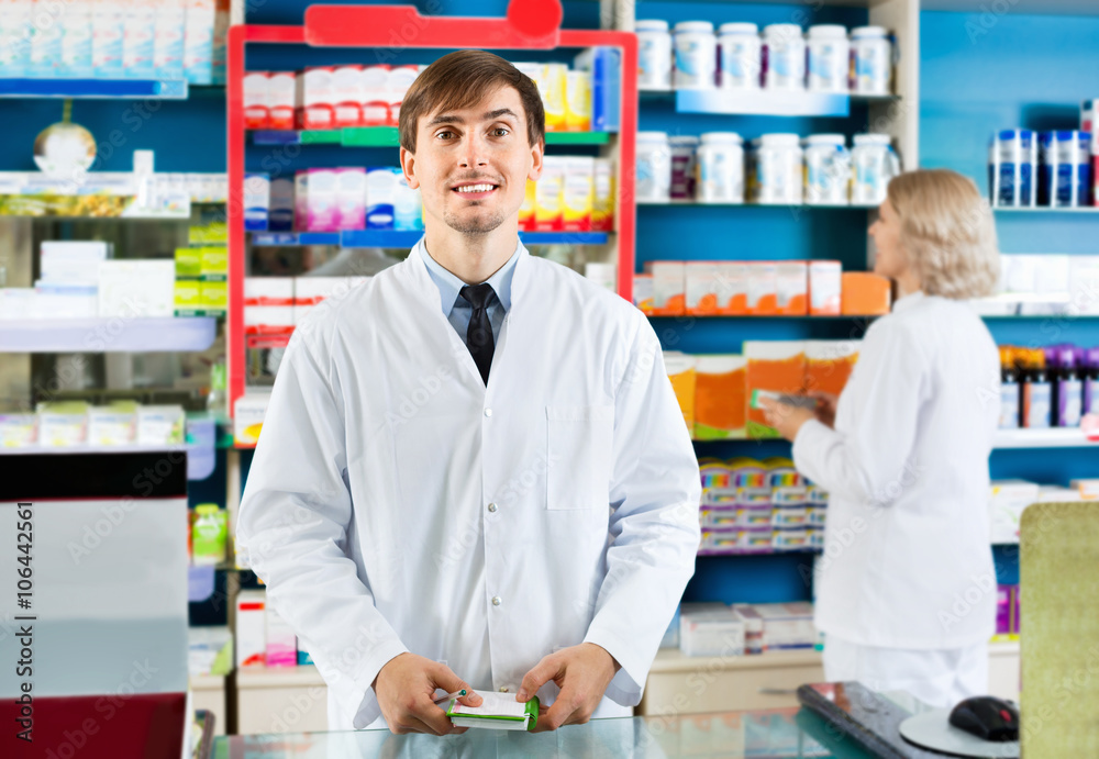 Portrait of two  pharmacists working in modern farmacy