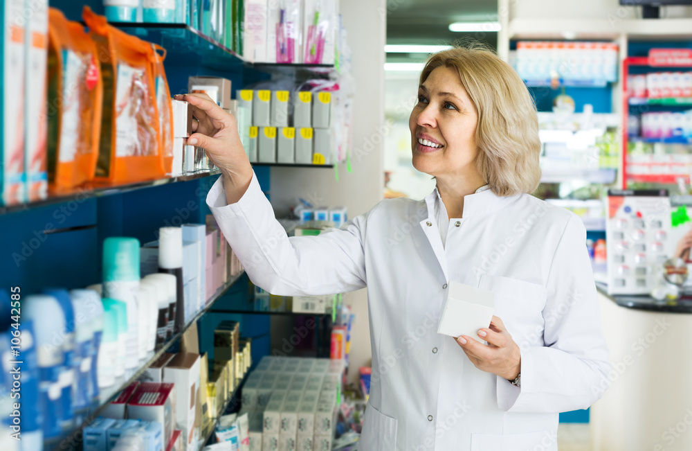 female pharmacist   posing in drugstore