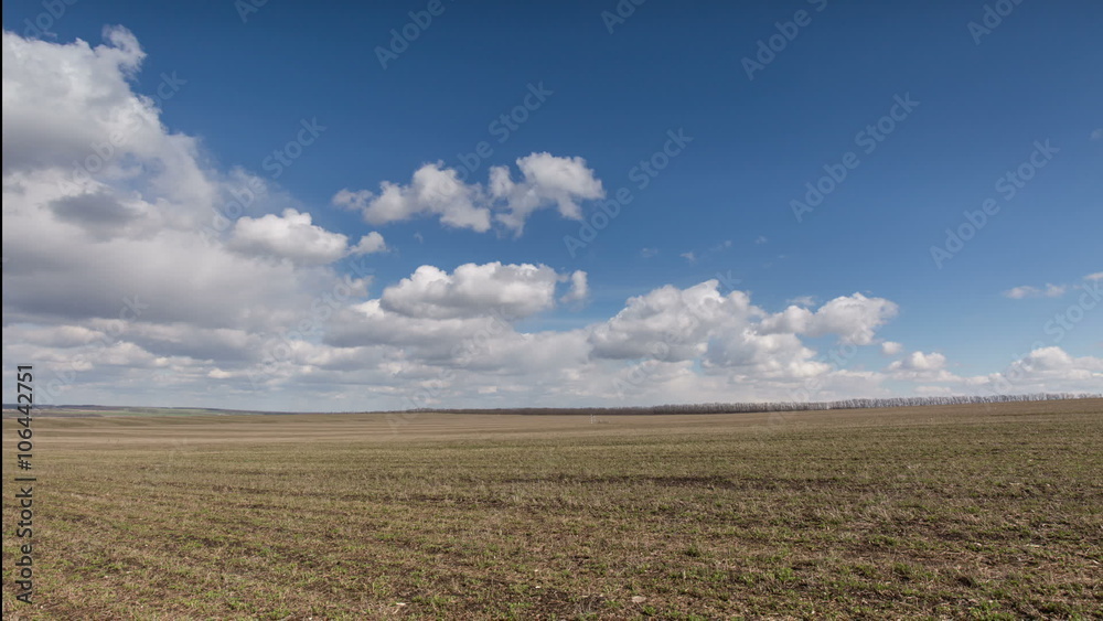 Russia, timelapse. The movement of clouds over the fields of winter wheat in early spring in the vast steppes of the Don.