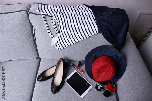 Composition of woman's fashion look on a gray couch