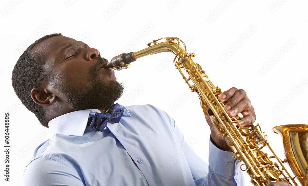 Fototapeta premium African American jazz musician playing the saxophone, isolated on white