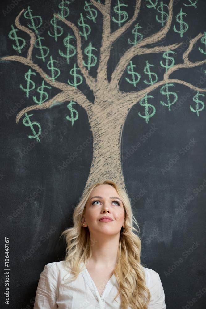 Happy blonde Business woman in front of chalk money tree drawing