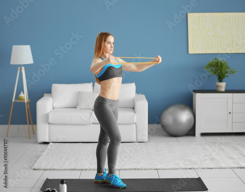 Young sportswoman doing exe...