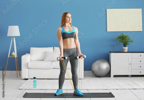 Young sportswoman doing exe...