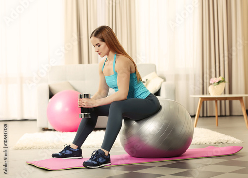 Young sportswoman doing exe...