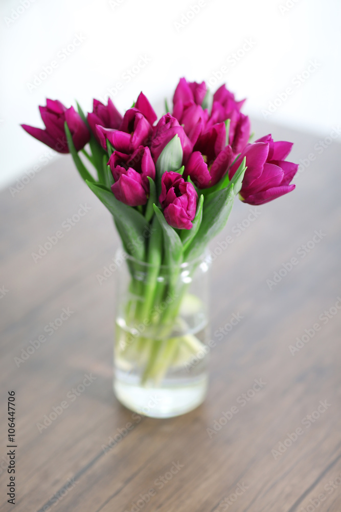 Beautiful bouquet of purple tulips on wooden table at living room Beautiful bouquet of purple tulips on wooden table at living room