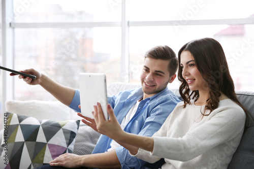 Young couple with tablet wa...