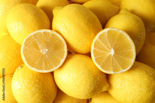 Pile of wet lemons with halves closeup