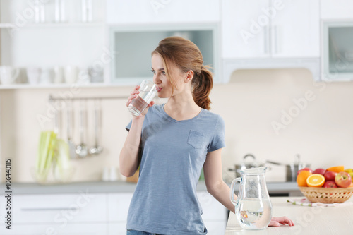 Young woman drinking water ...