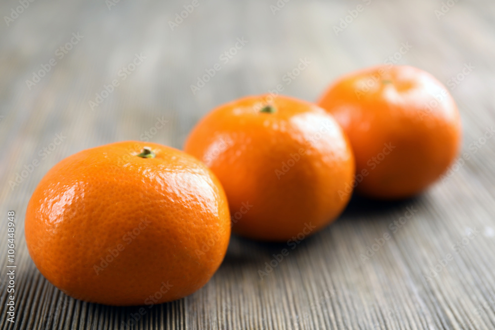 Fresh delicious tangerines lined on the wooden table, close up Fresh delicious tangerines lined on the wooden table, close up