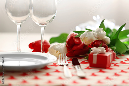 Bouquet of tulips on a table set for one  close up