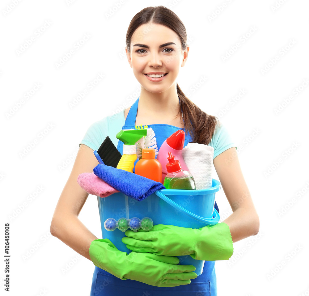 Young woman holding cleaning tools and products in bucket, isolated on white Young woman holding cleaning tools and products in bucket, isolated on white