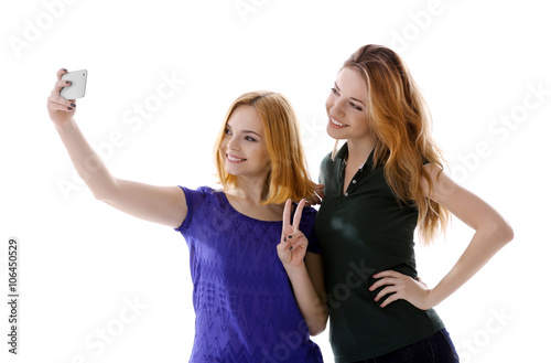 Two young women taking self...