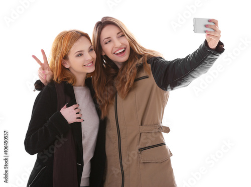 Two young women taking self...