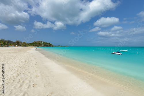 Tropical beach at Antigua island in Caribbean with white sand, t