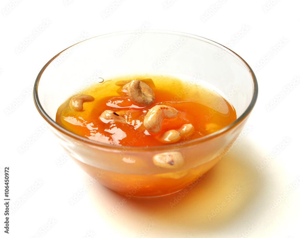 Sweet apricot jam in the transparent glass bowl with cashew nuts Sweet apricot jam in the transparent glass bowl with cashew nuts