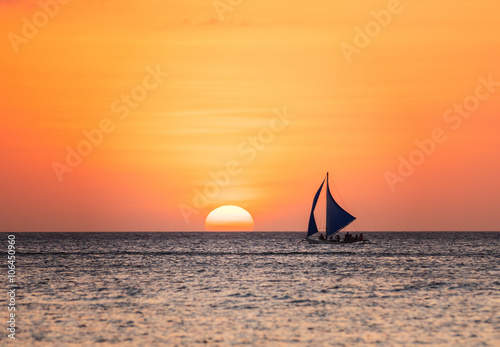 Sunset seascape with a sailboat