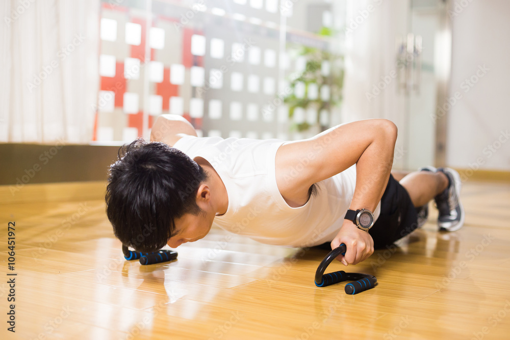 young handsome asian man works out in modern gym young handsome asian man works out in modern gym