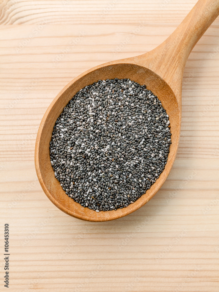 Nutritious chia seeds in wooden spoon for diet food ingredients. Nutritious chia seeds in wooden spoon for diet food ingredients.