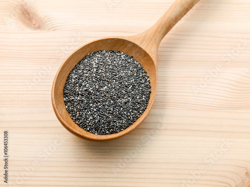 Nutritious chia seeds in wooden spoon for diet food ingredients.