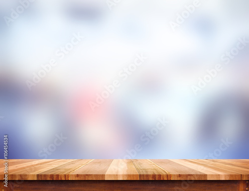 Empty light wood table top with blur abstract background, Leave